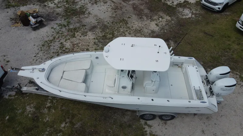 Slide: The Image of 1997 Stamas 290 Tarpon boat on trailer, aerial view, white exterior, dual engines. - 11
