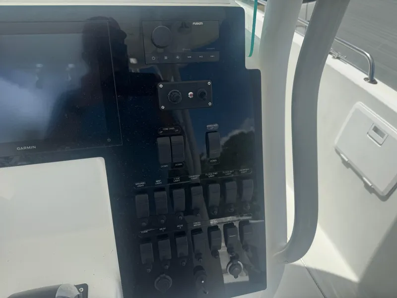 Slide: The Image of Control panel of a 1997 Stamas 290 Tarpon boat with various switches and displays. - 17