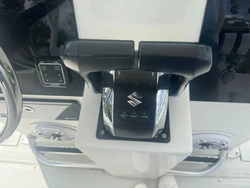 Slide: The Image of Throttle controls on a 1997 Stamas 290 Tarpon boat dashboard. - 18