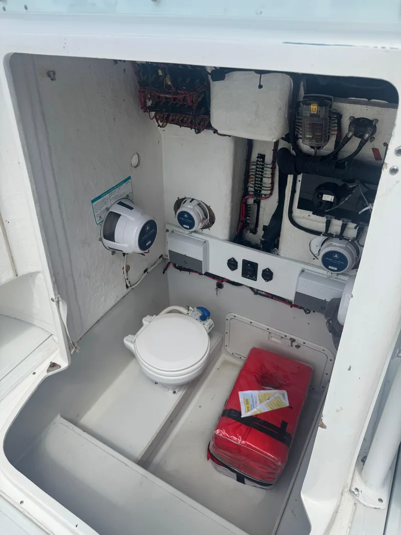 Slide: The Image of 1997 Stamas 290 Tarpon boat interior with toilet and storage compartment. - 20
