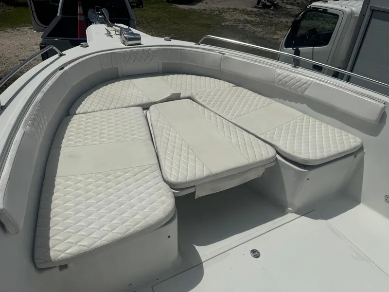 Slide: The Image of 1997 Stamas 290 Tarpon boat with white cushioned seating area. - 27