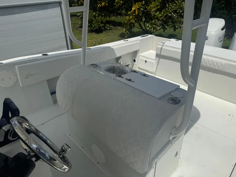 Slide: The Image of 1997 Stamas 290 Tarpon boat interior with white seating and steering wheel. - 28