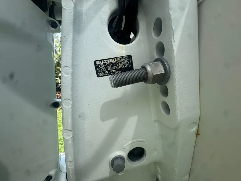 Slide: The Image of Close-up of a 1997 Stamas 290 Tarpon boat engine component with Suzuki label. - 36