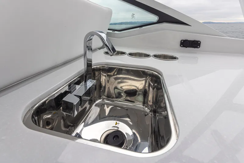 Slide: The Image of 2024 Blackfin 272 DC boat sink with modern chrome faucet and cup holders. - 15