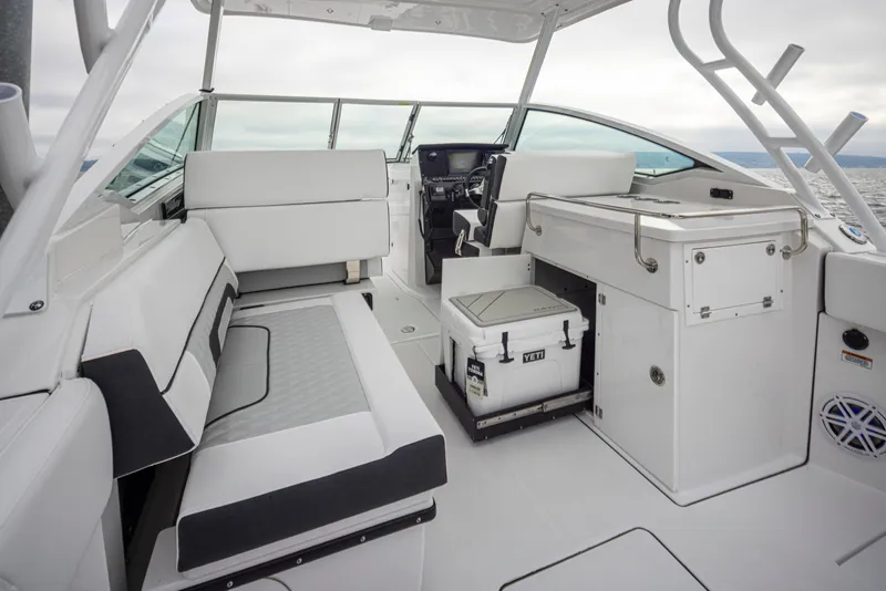Slide: The Image of 2024 Blackfin 272 DC boat interior with seating, storage, and Yeti cooler. - 17