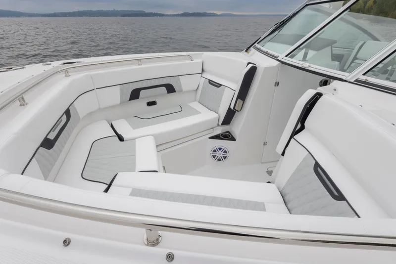 Slide: The Image of 2024 Blackfin 272 DC boat interior with white seating, on a calm lake. - 19