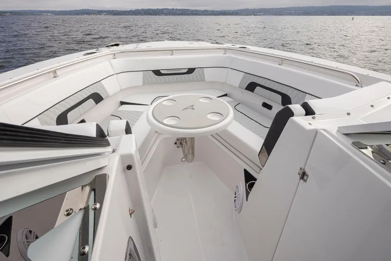 Slide: The Image of 2024 Blackfin 272 DC boat interior with seating and table on open water. - 20