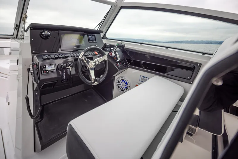 Slide: The Image of 2024 Blackfin 272 DC boat cockpit with modern controls and steering wheel. - 23