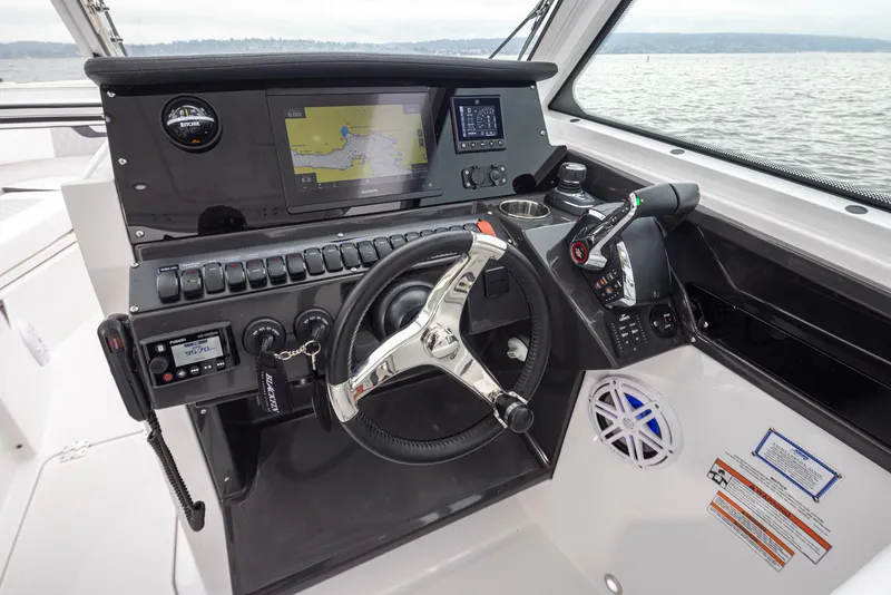 Slide: The Image of 2024 Blackfin 272 DC boat dashboard with navigation and control systems. - 24