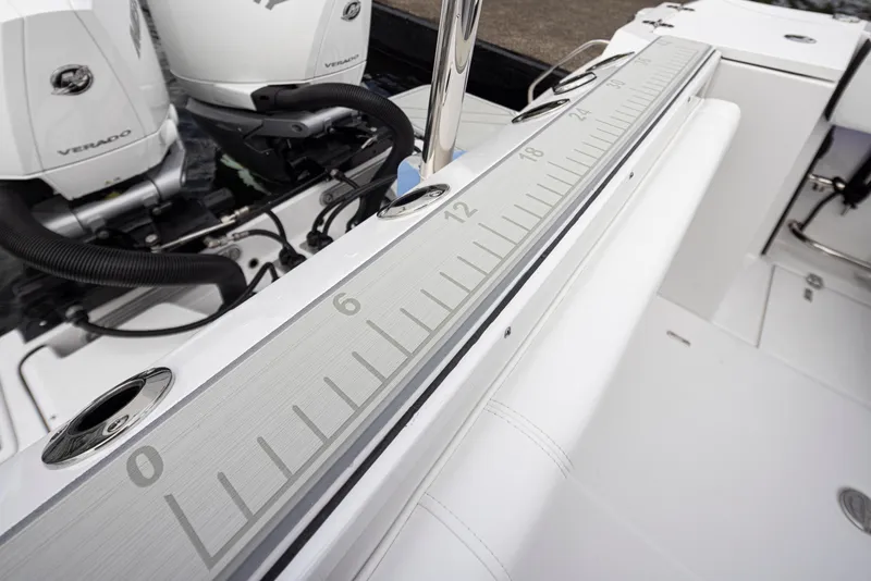 Slide: The Image of 2024 Blackfin 272 DC boat with dual Verado engines and integrated measuring ruler. - 28