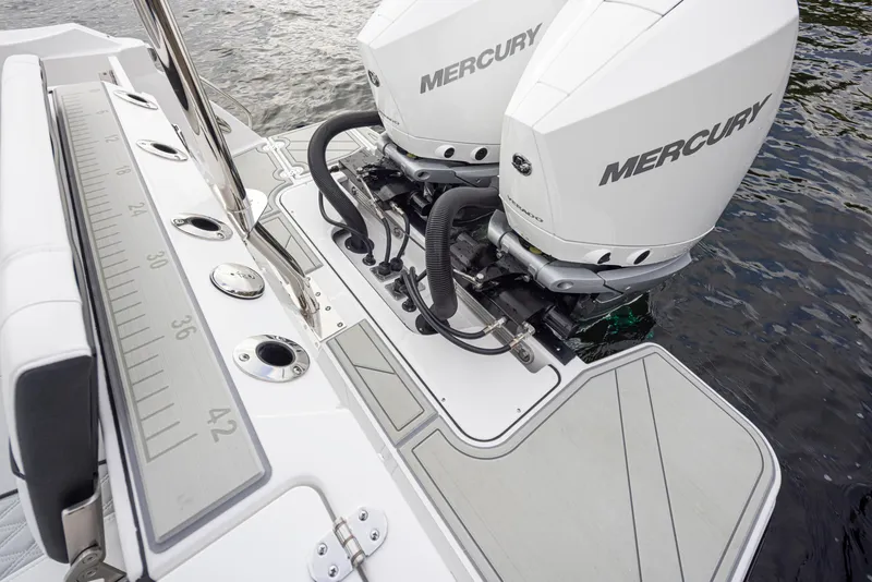 Slide: The Image of 2024 Blackfin 272 DC boat with dual Mercury outboard engines on water. - 29