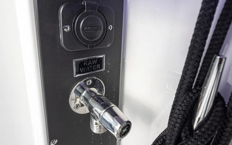 Slide: The Image of 2024 Blackfin 272 DC boat raw water outlet with black ropes. - 38