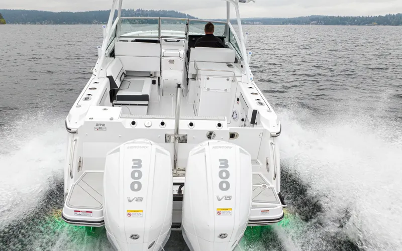 Slide: The Image of 2024 Blackfin 272 DC boat with dual Mercury 300 V8 engines cruising on a lake. - 5