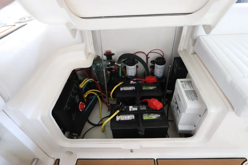 Slide: The Image of 2016 Robalo R265 Walkaround boat battery compartment with wiring and components. - 12