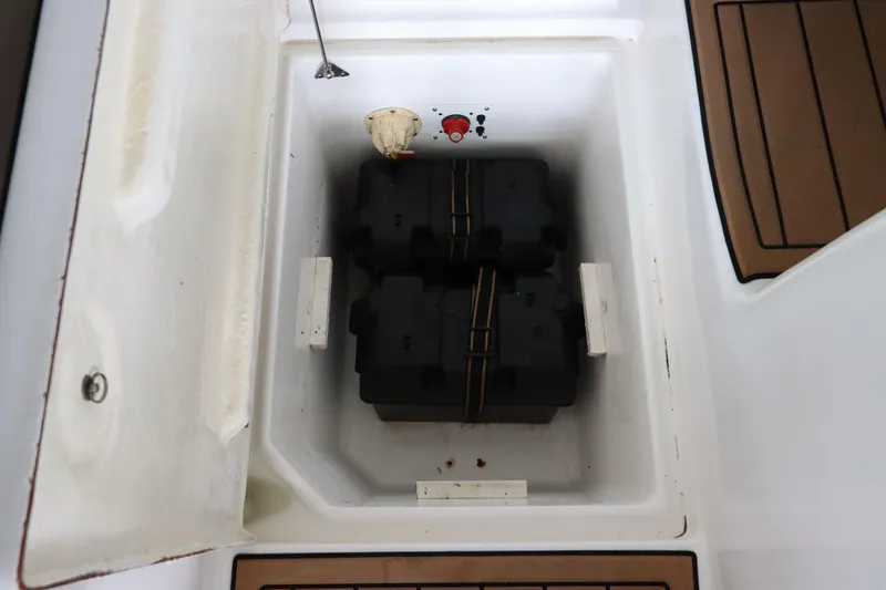 Slide: The Image of 2016 Robalo R265 Walkaround battery compartment with secured battery boxes. - 14