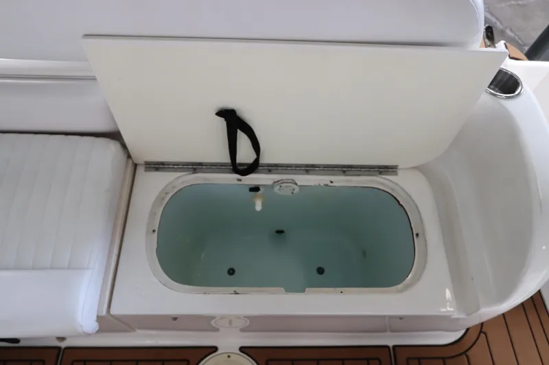 Slide: The Image of Livewell compartment on 2016 Robalo R265 Walkaround boat, open lid, white interior. - 16