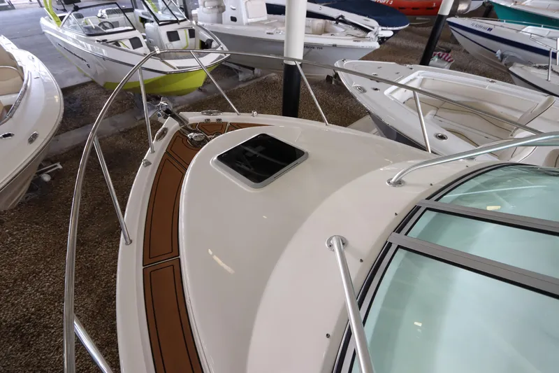 Slide: The Image of 2016 Robalo R265 Walkaround boat in showroom, featuring sleek design and spacious deck. - 18