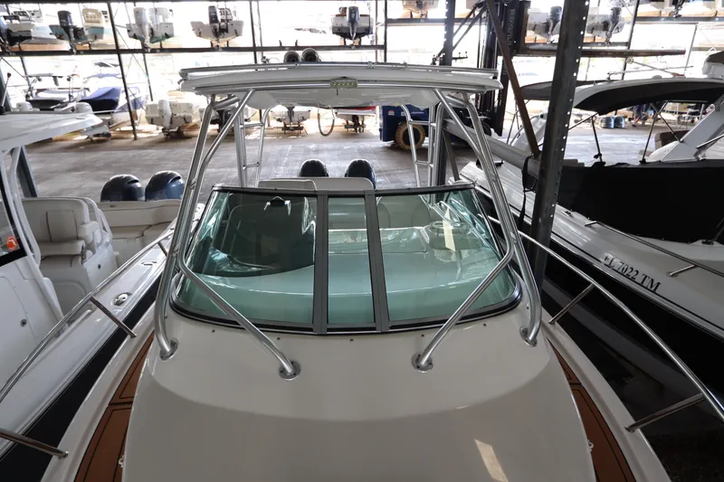 Slide: The Image of 2016 Robalo R265 Walkaround boat in storage, featuring sleek design and sturdy build. - 20