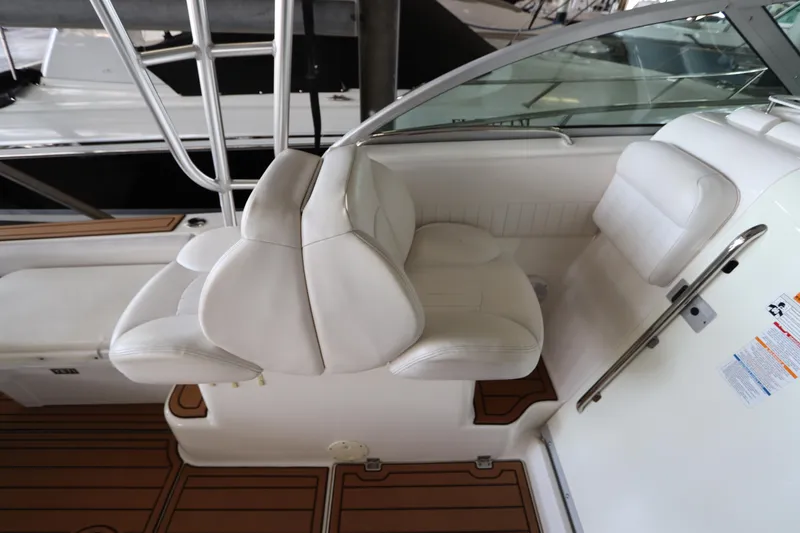 Slide: The Image of 2016 Robalo R265 Walkaround boat interior with white seating and wood accents. - 22