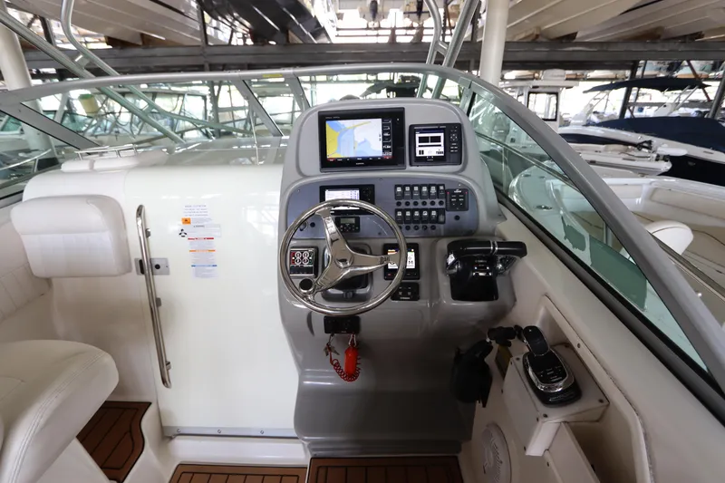 Slide: The Image of 2016 Robalo R265 Walkaround boat cockpit with steering wheel and navigation controls. - 27