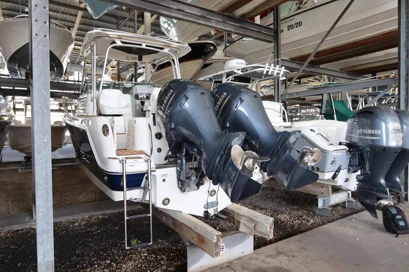Slide: The Image of 2016 Robalo R265 Walkaround boat with dual Yamaha outboard engines in storage. - 3