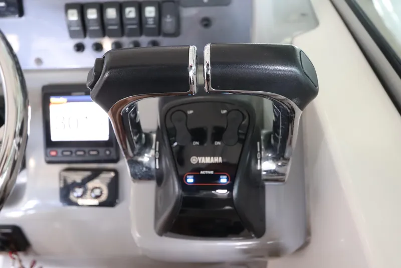 Slide: The Image of Yamaha throttle controls on 2016 Robalo R265 Walkaround boat dashboard. - 30