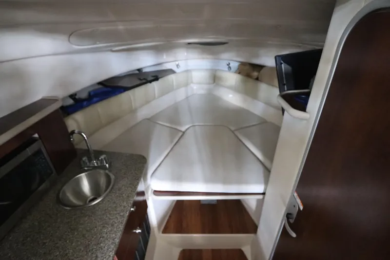 Slide: The Image of 2016 Robalo R265 Walkaround cabin interior with sink and seating area. - 39