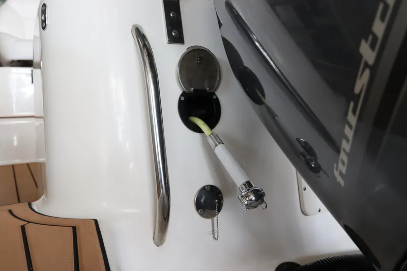 Slide: The Image of 2016 Robalo R265 Walkaround boat with four-stroke engine and fuel hose connection. - 8