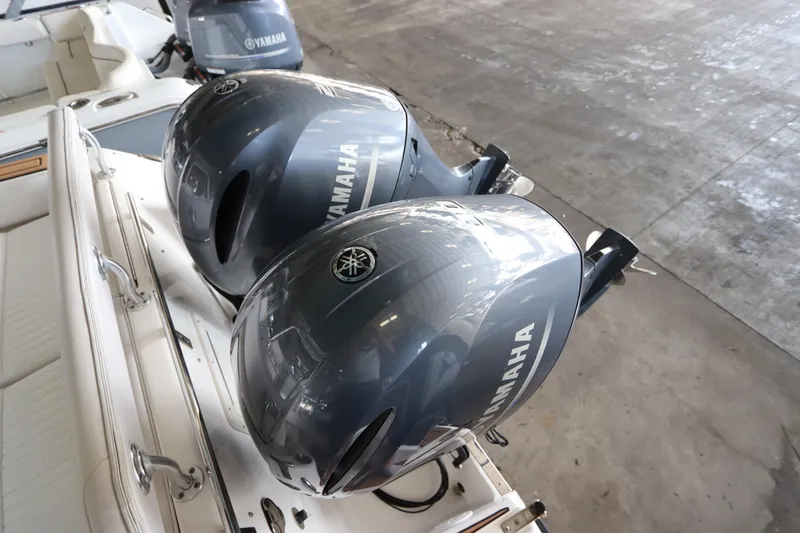 Slide: The Image of 2016 Robalo R265 Walkaround with dual Yamaha outboard engines in a garage setting. - 9