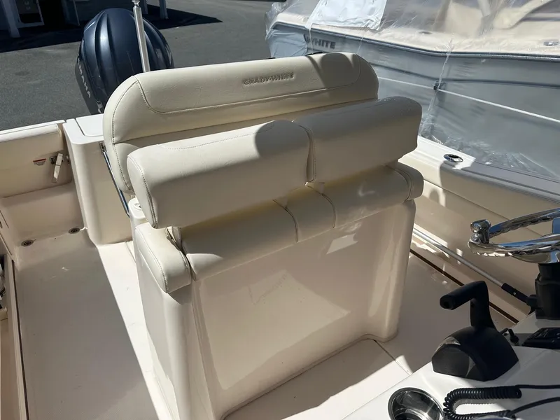 Slide: The Image of 2022 Grady-White 236 Fisherman boat interior with cushioned seating and steering wheel. - 10