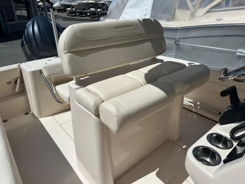 Slide: The Image of 2022 Grady-White 236 Fisherman boat interior with cushioned seating and cup holders. - 11