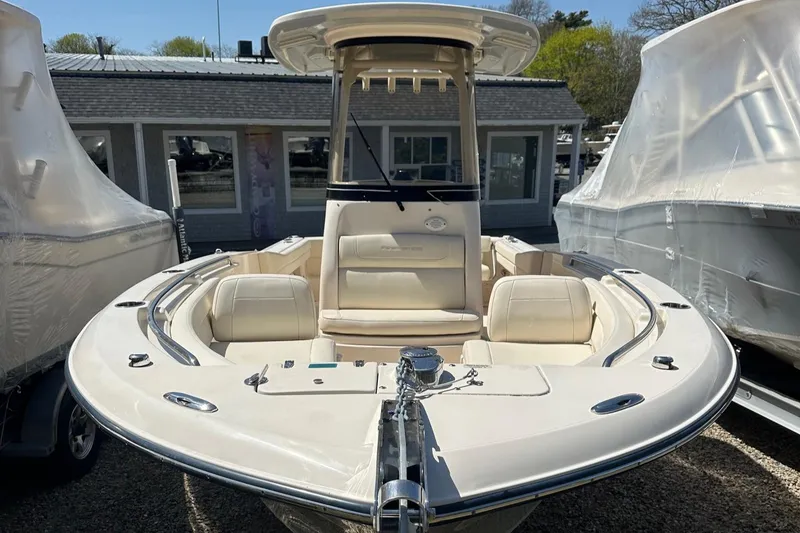 Slide: The Image of 2022 Grady-White 236 Fisherman boat, front view, docked with protective covers nearby. - 2