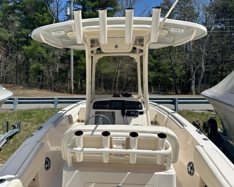 Slide: The Image of 2022 Grady-White 236 Fisherman boat with center console and rod holders, parked outdoors. - 3