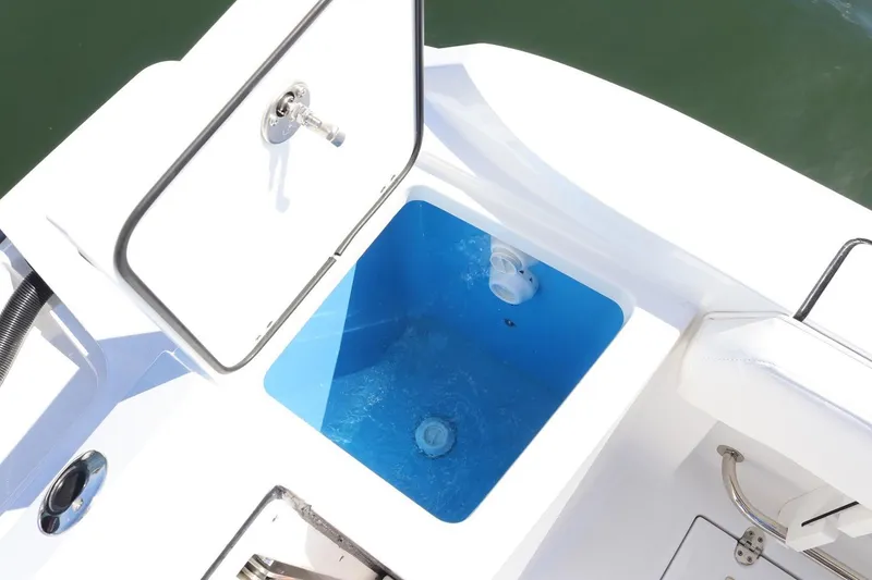 Slide: The Image of Open storage compartment on 2023 Blackfin 252 CC boat, featuring a blue interior. - 23