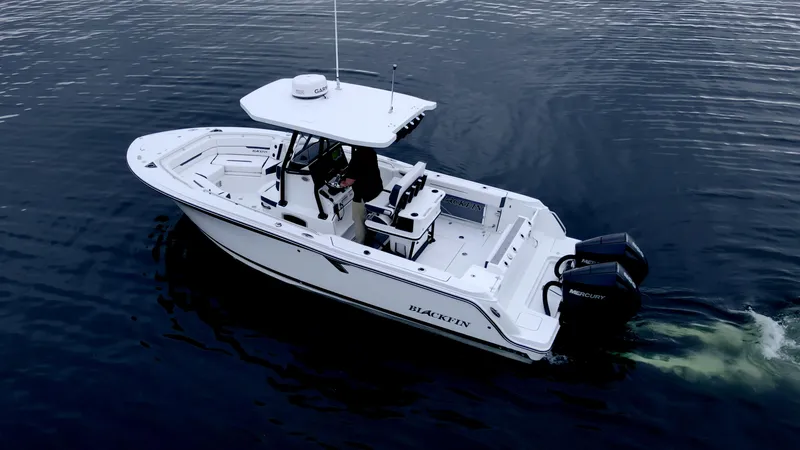 Slide: The Image of 2023 Blackfin 252 CC boat cruising on calm water, featuring dual Mercury engines. - 25