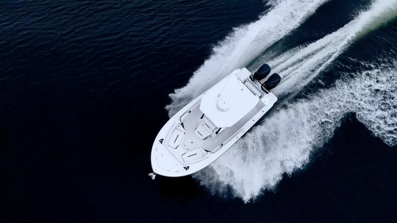 Slide: The Image of 2023 Blackfin 252 CC boat cruising on open water, aerial view. - 27