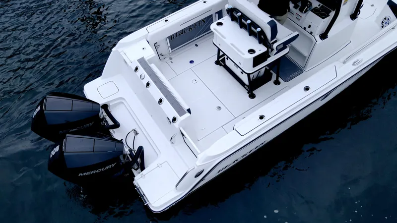 Slide: The Image of 2023 Blackfin 252 CC boat with dual Mercury engines on water. - 3