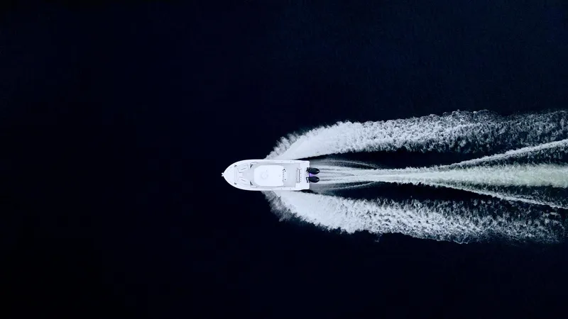 Slide: The Image of Aerial view of 2023 Blackfin 252 CC boat creating wake on dark water. - 30