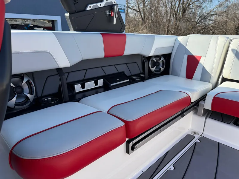 Slide: The Image of 2021 Malibu Wakesetter 23 LSV interior with red and white seating, speakers, and cup holders. - 14