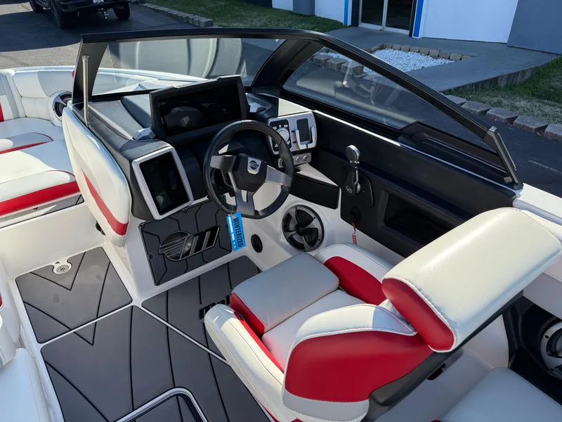 Slide: The Image of Interior of 2021 Malibu Wakesetter 23 LSV boat with modern dashboard and red-white seating. - 15