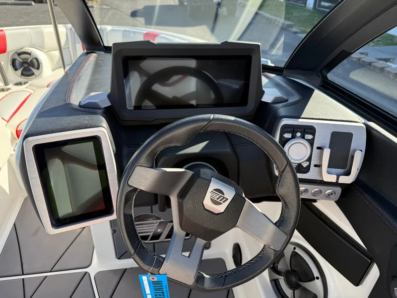 Slide: The Image of 2021 Malibu Wakesetter 23 LSV dashboard with steering wheel and digital displays. - 16