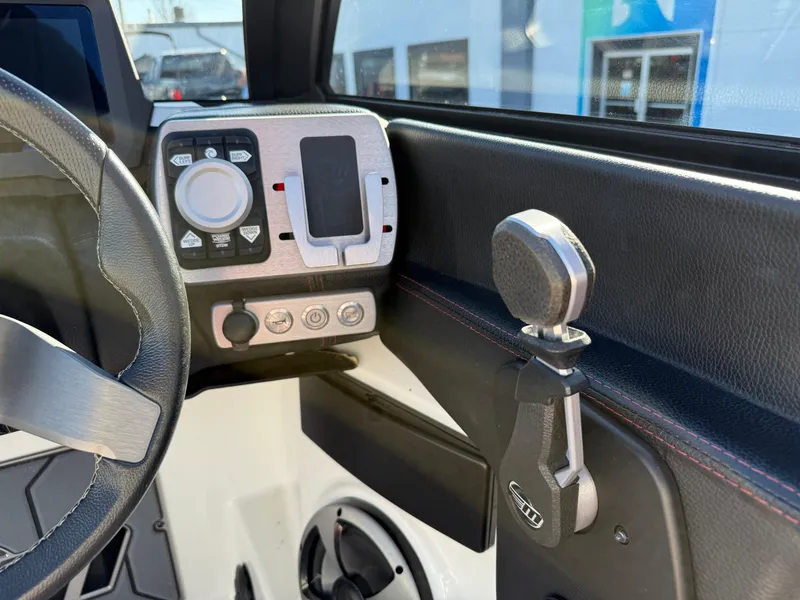 Slide: The Image of 2021 Malibu Wakesetter 23 LSV dashboard with steering wheel and control panel. - 18