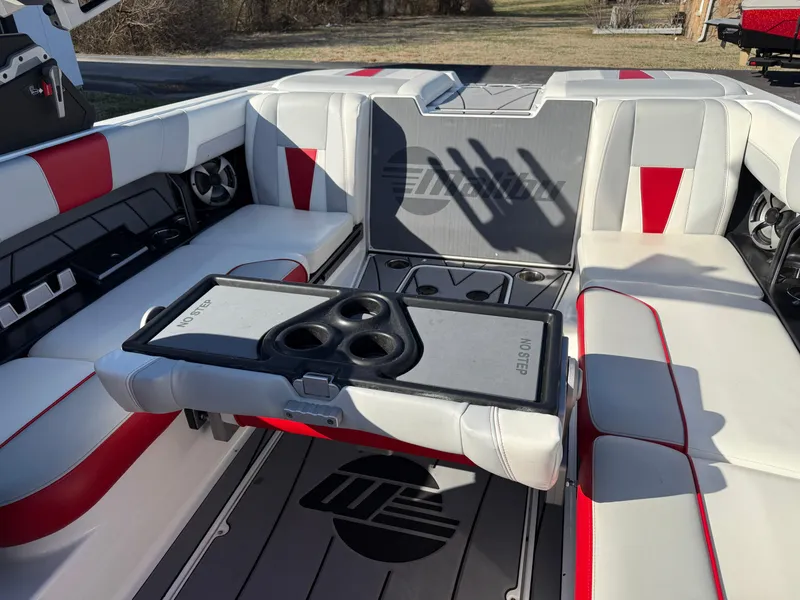 Slide: The Image of 2021 Malibu Wakesetter 23 LSV interior with red and white seating and cup holders. - 20