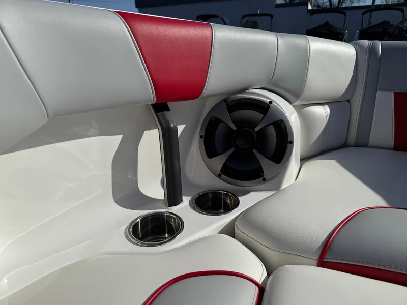 Slide: The Image of 2021 Malibu Wakesetter 23 LSV interior with speaker, cup holders, and red-accented seating. - 24