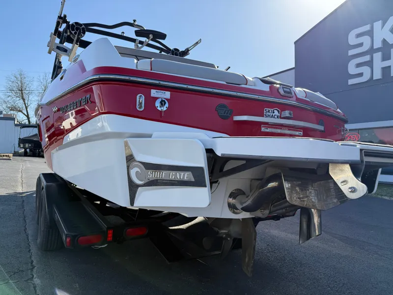 Slide: The Image of 2021 Malibu Wakesetter 23 LSV boat, red and white, rear view with Surf Gate feature. - 8