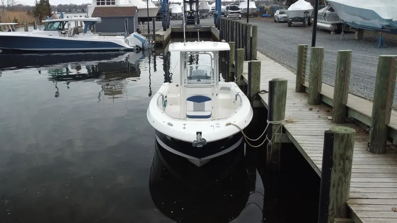 Slide: The Image of 2020 Robalo R242 Explorer boat docked at a marina, front view. - 15