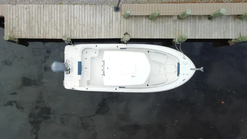 Slide: The Image of Overhead view of a 2020 Robalo R242 Explorer docked at a wooden pier. - 16