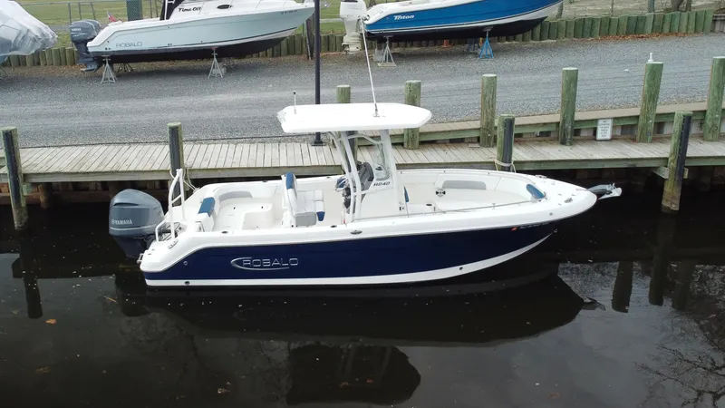 Slide: The Image of 2020 Robalo R242 Explorer boat docked, featuring sleek design and modern amenities. - 17