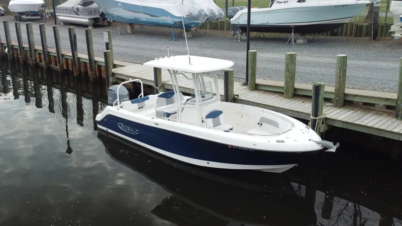 Slide: The Image of 2020 Robalo R242 Explorer boat docked in a marina, featuring sleek design and spacious deck. - 18