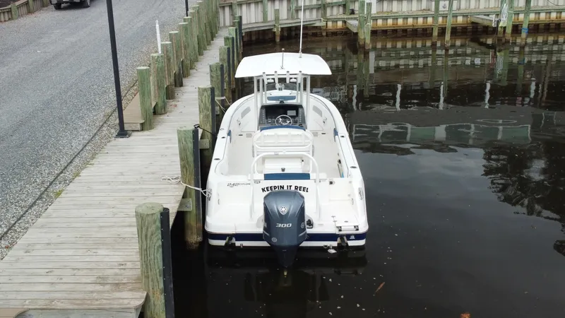 Slide: The Image of 2020 Robalo R242 Explorer docked at a marina, rear view. - 19